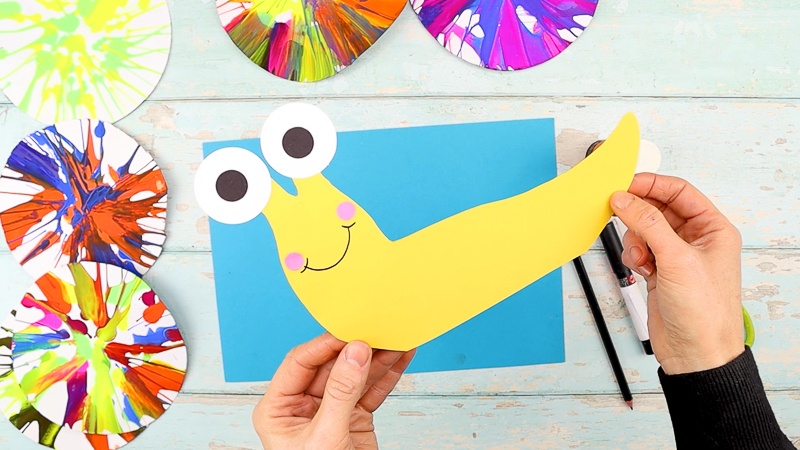 Assemble the snail: adding eyes, a smile and cute little cheeks.