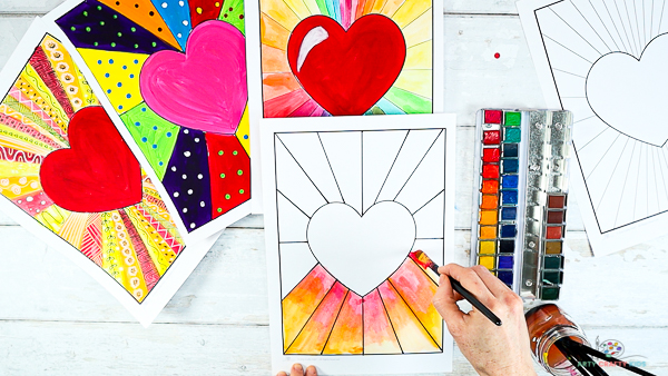 Image showing hands painting the bottom area of the heart sunburst template red, orange and yellow.