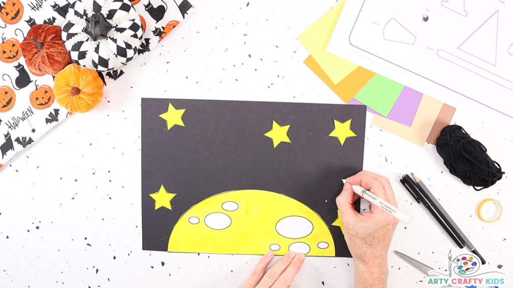 Image featuring a hand drawing white dots onto the starry night backdrop.