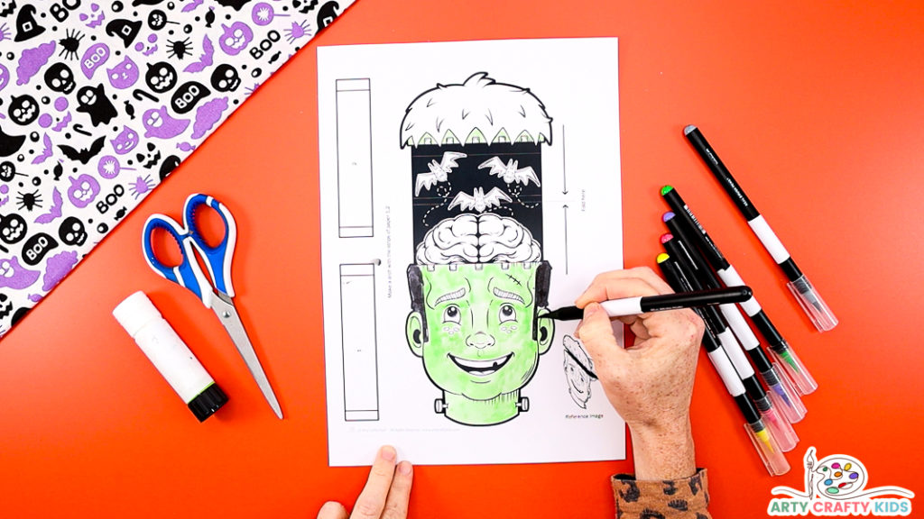 Image Step 1: Coloring in the printable Frankenstein paper hand puppet.