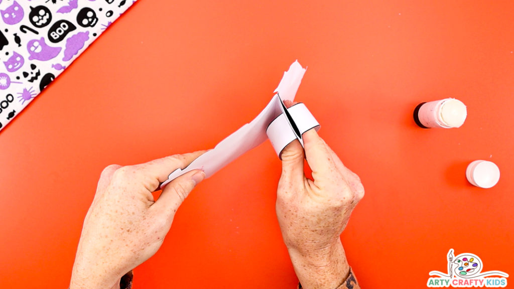 Image Step 4: Glueing the paper strips onto the folds.