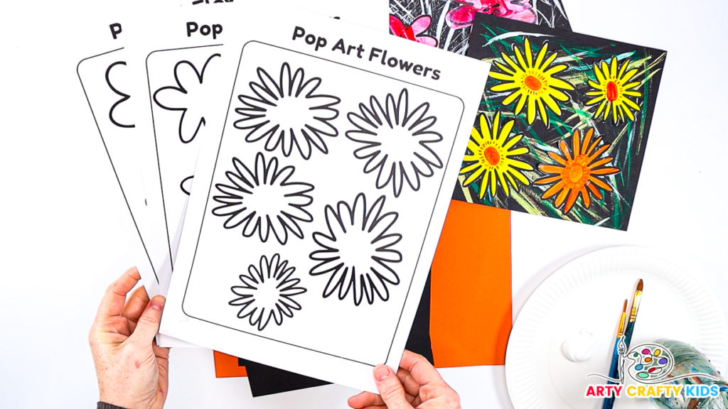 Image featuring a hand holding the 3 printable flower templates for kids to paint and decorate to create flower pop art.