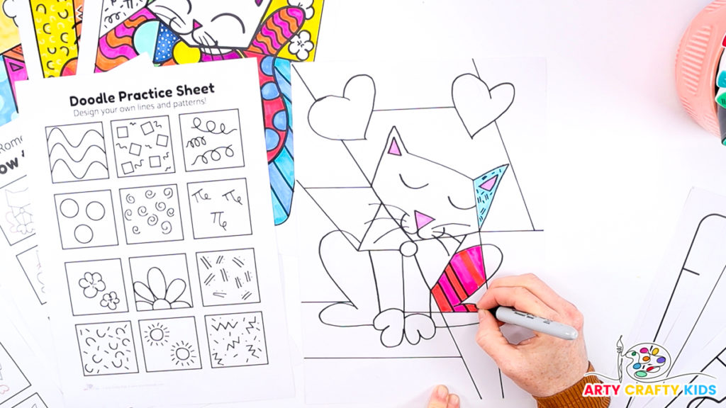 Image of a hand coloring in the cat drawing.