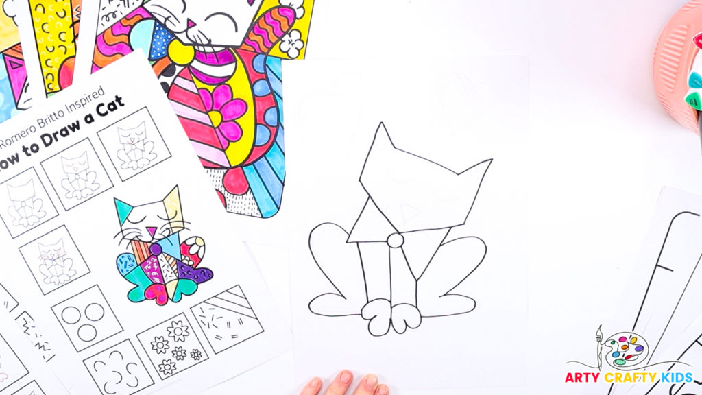 Image of a hand using the how-to-draw step-by-step printable to draw Britto's cat's hind legs.