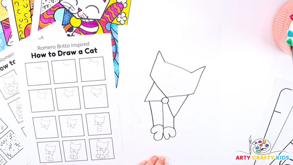 Image of a hand using the how-to-draw step-by-step printable to draw Britto's cat's legs and paws.