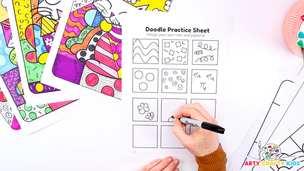 Image of a hand using the doodle practice printable sheet to design Romero Britto inspired patterns.