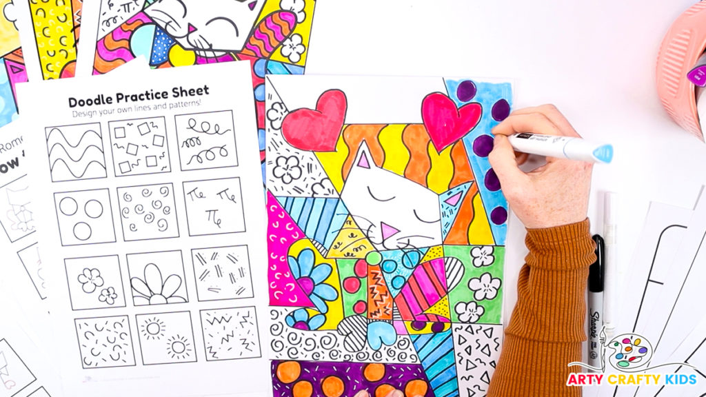 Image of a hand drawing doodles and patterns within the segmented cat drawing.