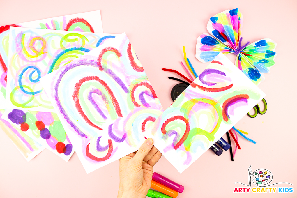 Image of a hand cutting the a4 sheet of paper into a square and rectangle.