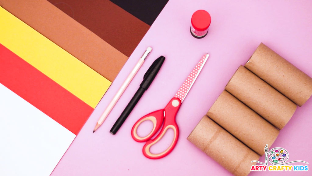 Image of a collection of craft materials for the paper roll dog pencil holder, including 4 paper rolls, collection of colorful papers, scissors, pencil, pen and glue stick.