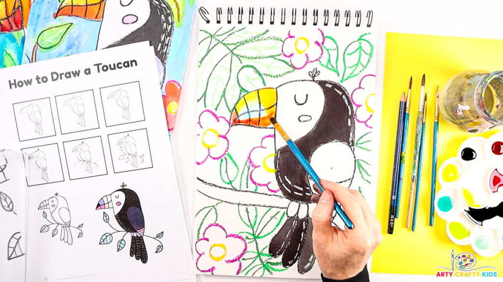 Image of step 8 of a hand using watercolor paint to color in toucan.