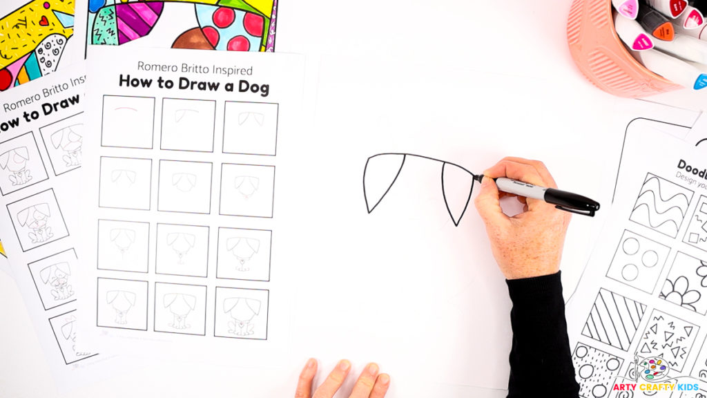 A hand drawing step 1 and step 2 of the Romero Britto Dog.