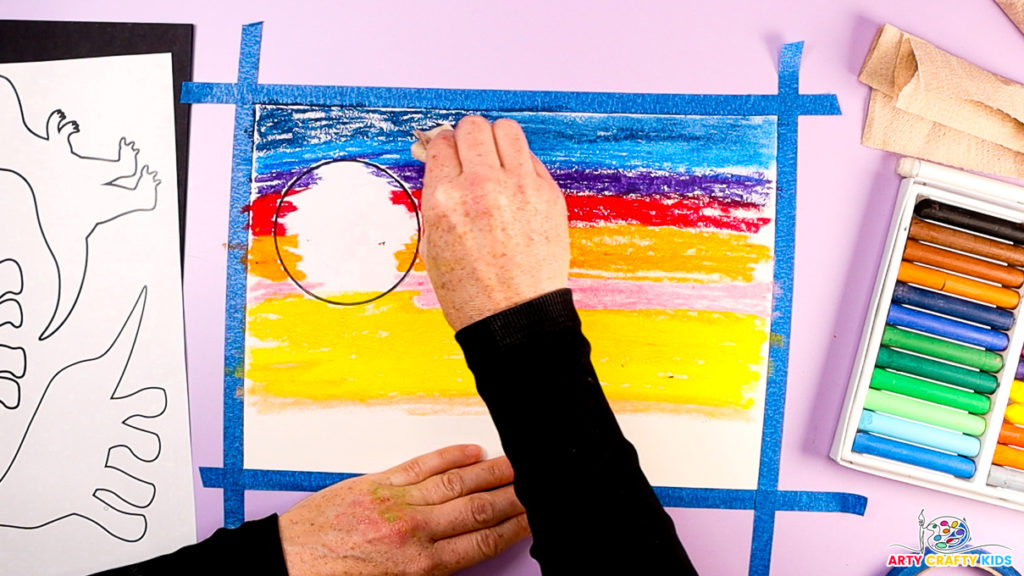 Image of a hand blending the blue shades with a blending tool.