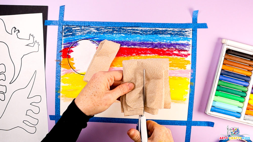 Image of a hand creating a blending tool out of kitchen roll paper.