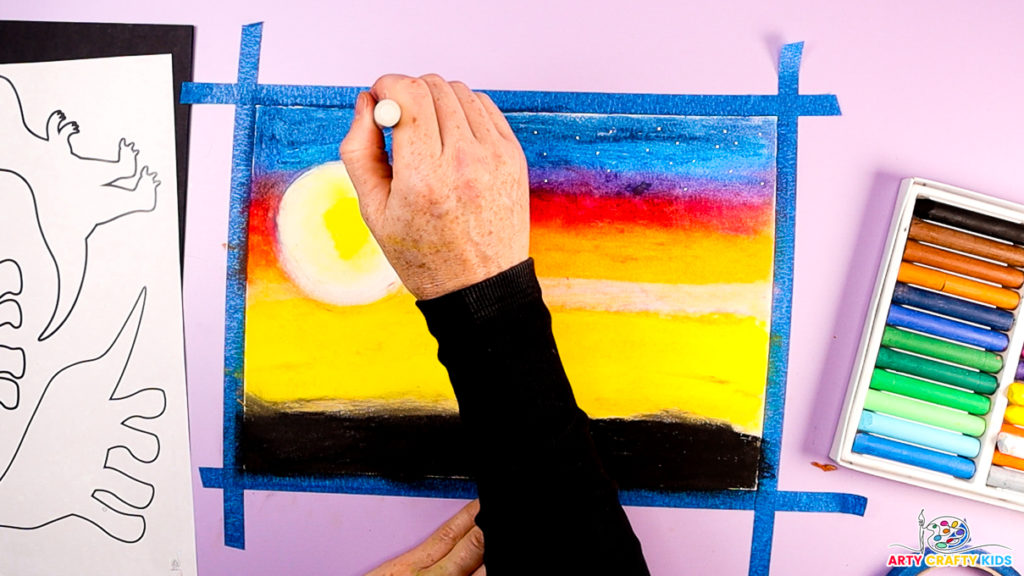 Image of a hand using a white acrylic marker to add white dots to the blue sky.