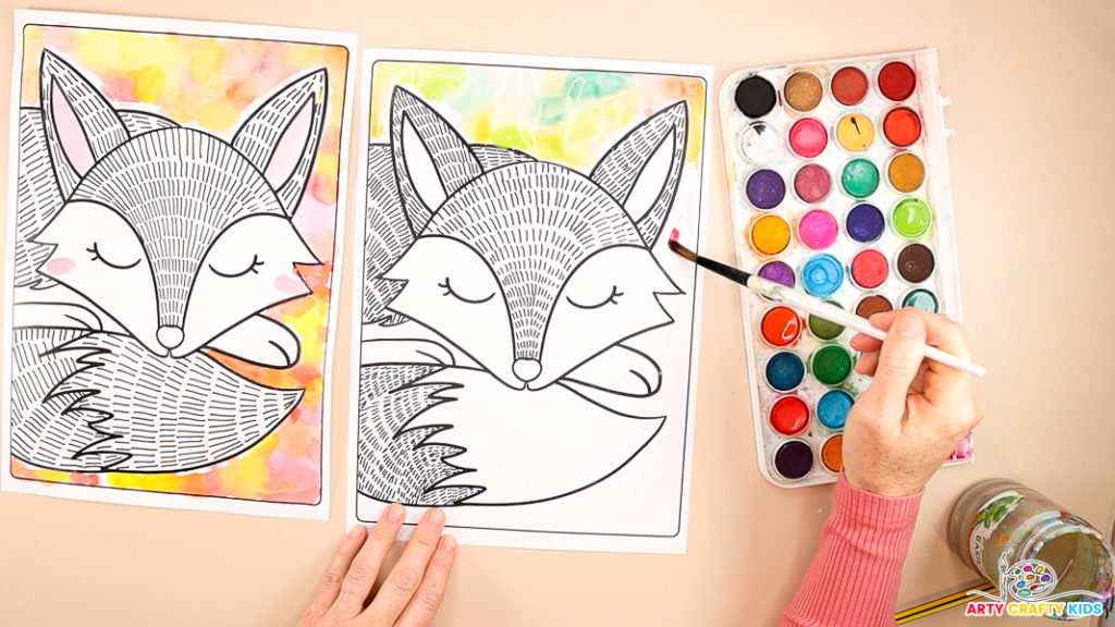 An image shows a hand painting watercolor circles around the fox's head in green.