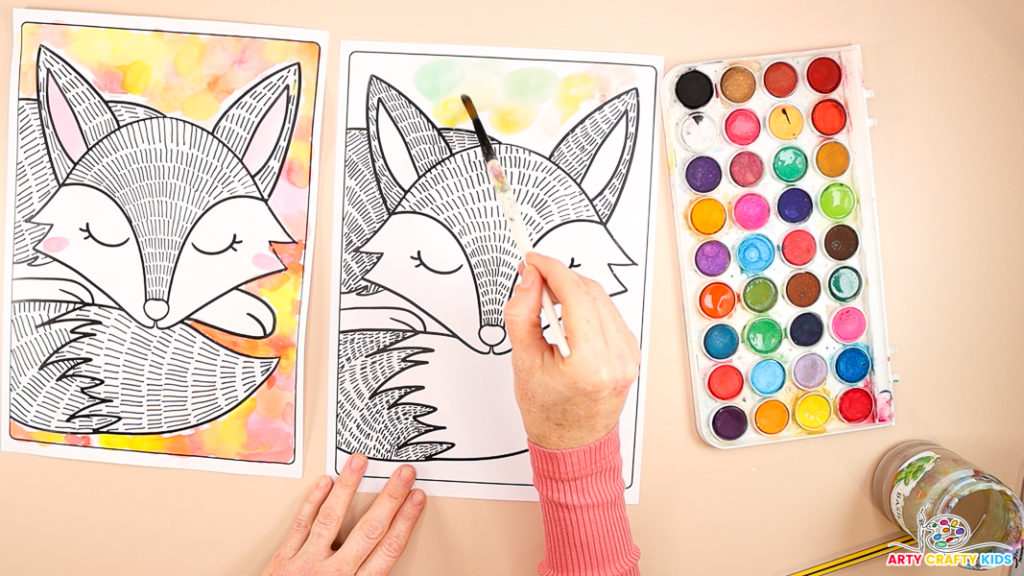 An image shows a hand painting watercolor circles around the fox's head in green.