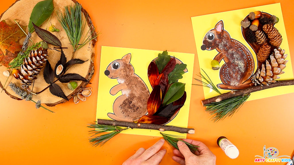 Image of a hand gluing a stock and pine needles below the squirrel to create the impression of a squirrel sitting on a branch.