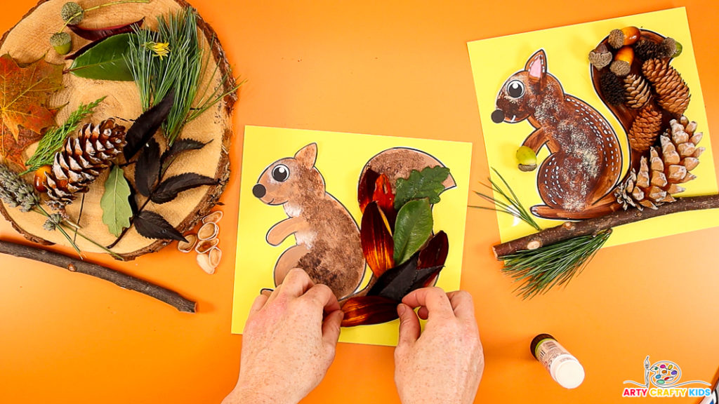 Image of a hand layering petals and leaves within the squirrel's tail.