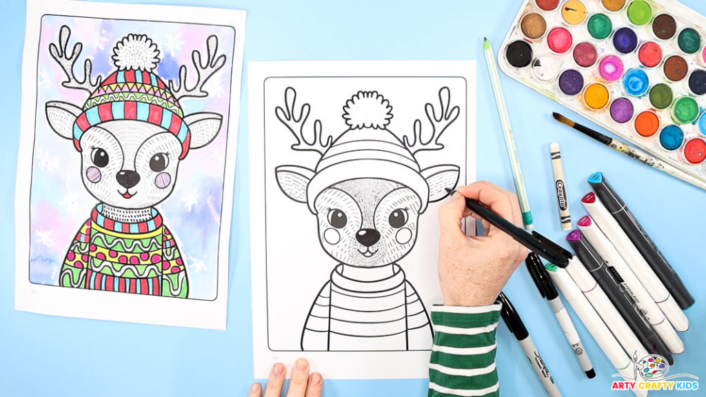 Image of a hand drawing little lines within the reindeer's ears.