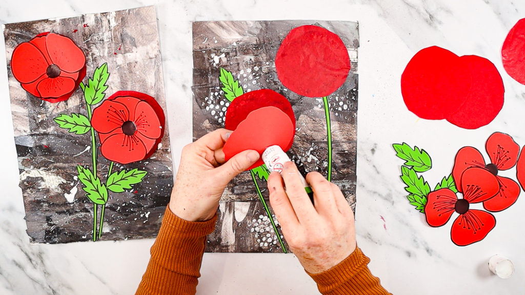 Image features a hand applying glue to the back of the base poppy layer.