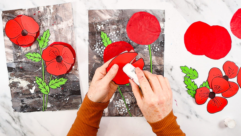 Image features a hand applying glue to the straight edge of the base poppy layer.