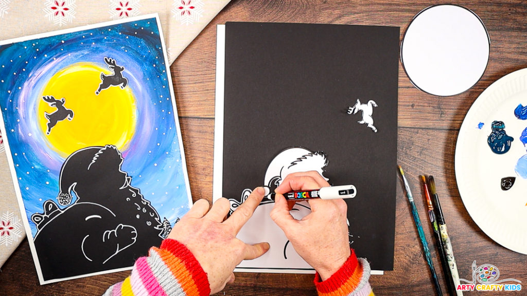 Image features a hand tracing around the Santa silhouette with a white marker pen.