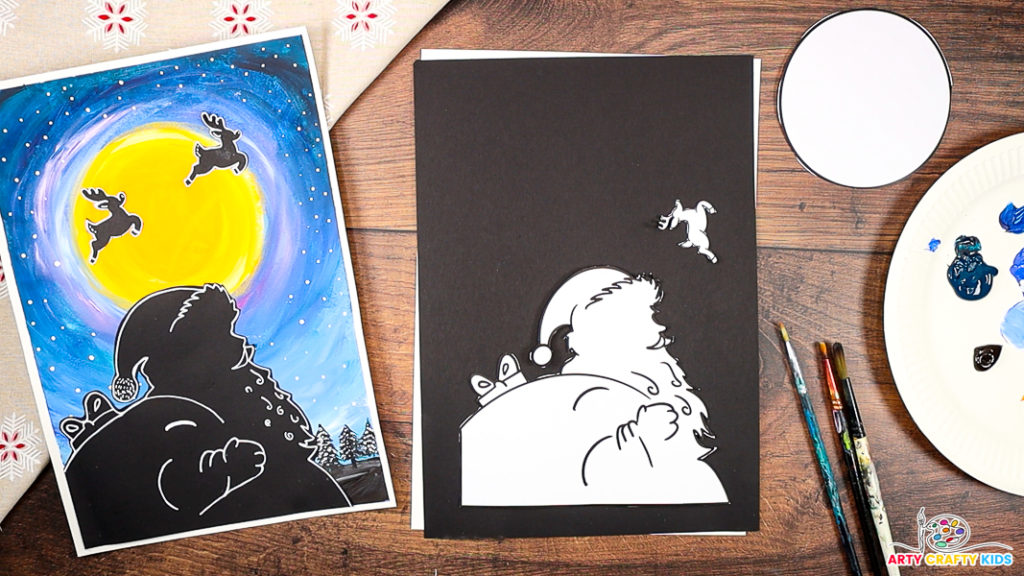 A step-by-step Santa silhouette art project featuring a painted night sky with a glowing yellow moon and reindeer silhouettes. The image shows a completed artwork alongside the cut-out Santa silhouette and craft materials, including paintbrushes, paint, and a circular moon template, ready for crafting.