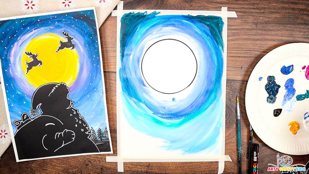 A step-by-step Christmas craft featuring a painted night sky in progress, with shades of blue swirling around a blank circular moon template. The completed Santa silhouette artwork is shown on the left as inspiration, while paints, brushes, and a palette with various colors are displayed on the right, ready for use.