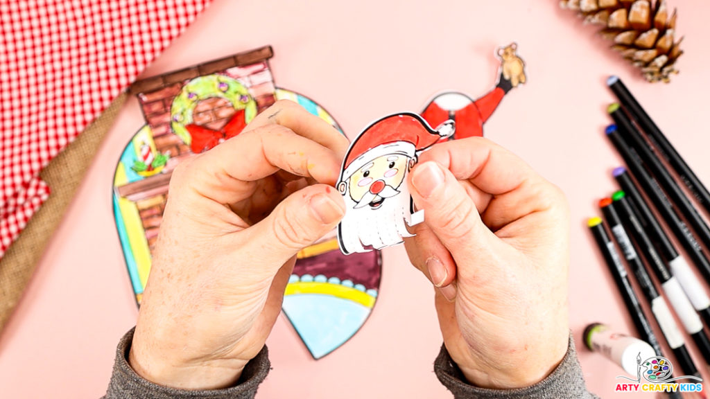 Image features a pair of hands showcasing Santa's curly paper beard.