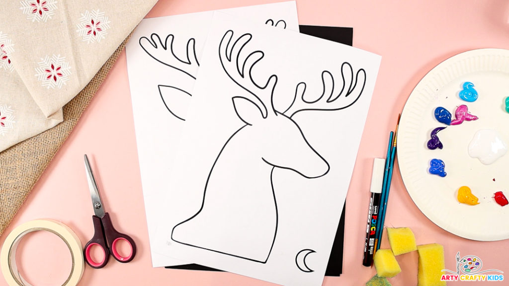 The image features the reindeer silhouette template, surrounded by art materials, including tape, paint, sponges, and scissors.