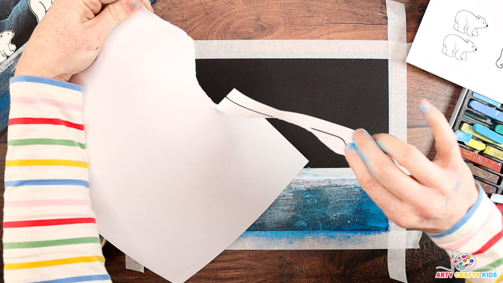 Image of a hand tearing a piece of paper to create a jagged edge.