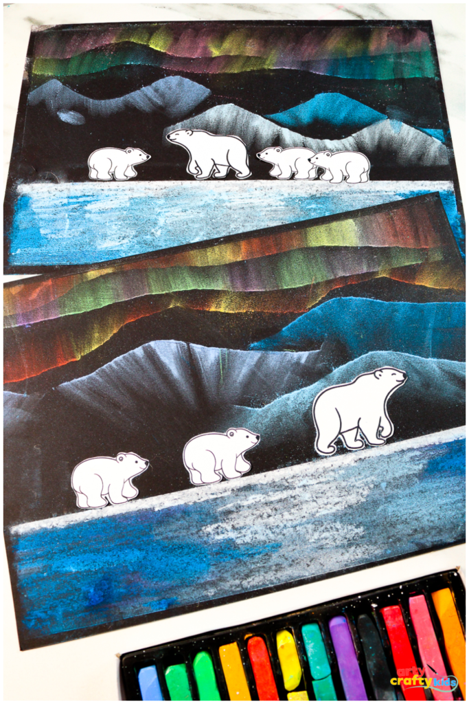 Chalk pastel art featuring vibrant Northern Lights, snow-capped mountains, and reflective water, complete with a family of polar bear cutouts, perfect for a kids' Arctic-themed craft project.