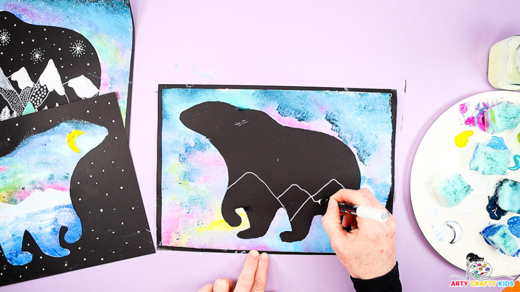 Image of a hand drawing a collection of triangles within the black polar bear silhouette.