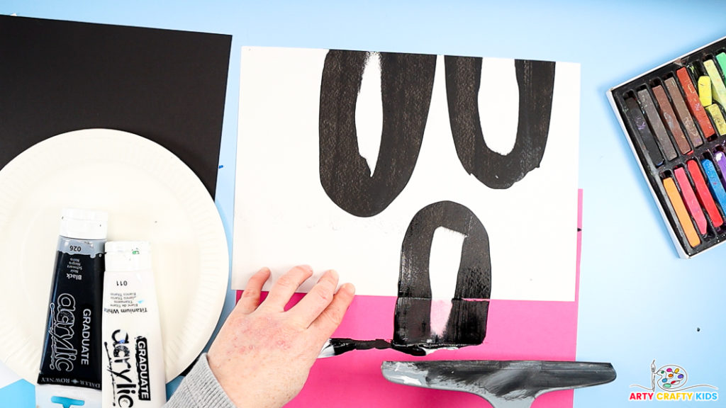 Image featuring a hand squeegee scrape painting to make a penguin's body.