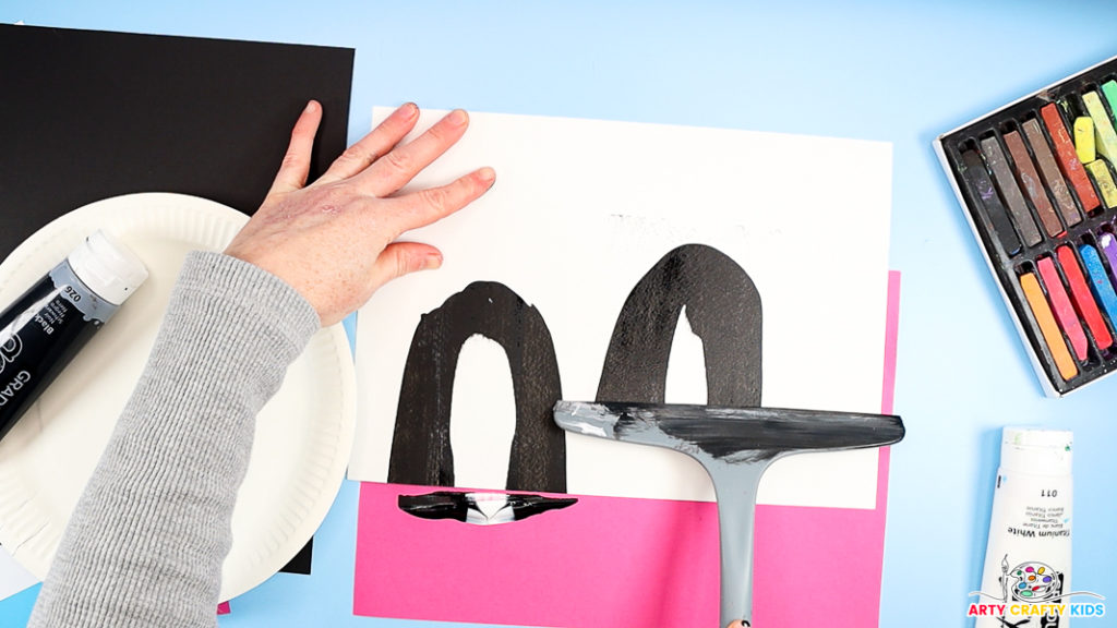 Image featuring a hand squeegee scrape painting to make a penguin's body.