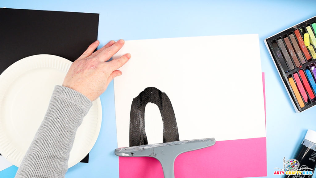 Image featuring a hand squeegee scrape painting to make a penguin's body.