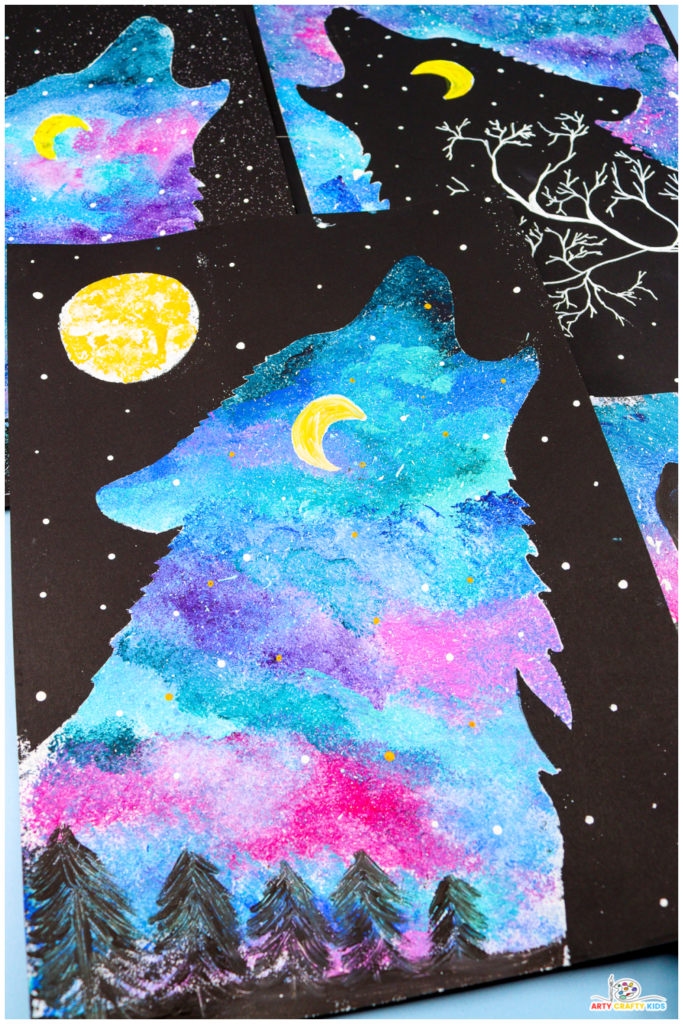 A close-up of colorful Wolf Silhouette Paintings featuring vibrant northern lights-inspired skies in shades of blue, pink, and purple. The silhouettes include glowing yellow moons, white stars, and pine tree details, creating a magical and imaginative art project.